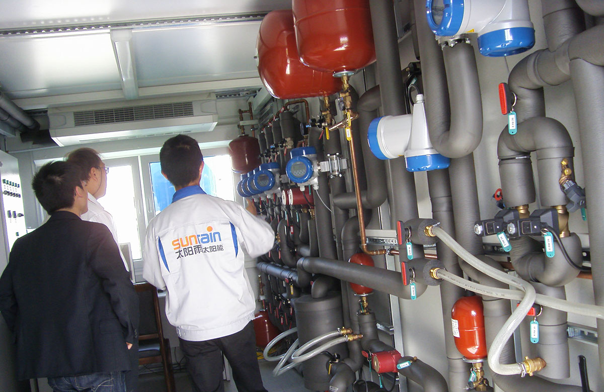 3 Sunrain Technology experts examining piping and valves